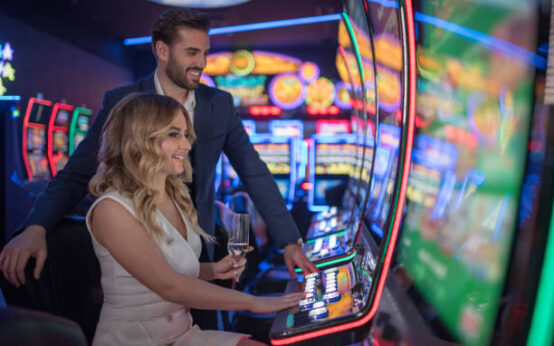 handsome couple having fun and drinking wine at casino