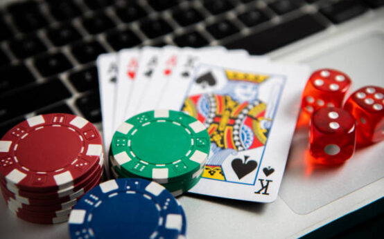 Poker chips and cards on computer keyboard